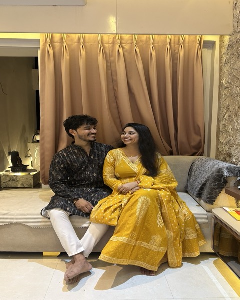 The two of us sitting together, one in a mustard-yellow suit