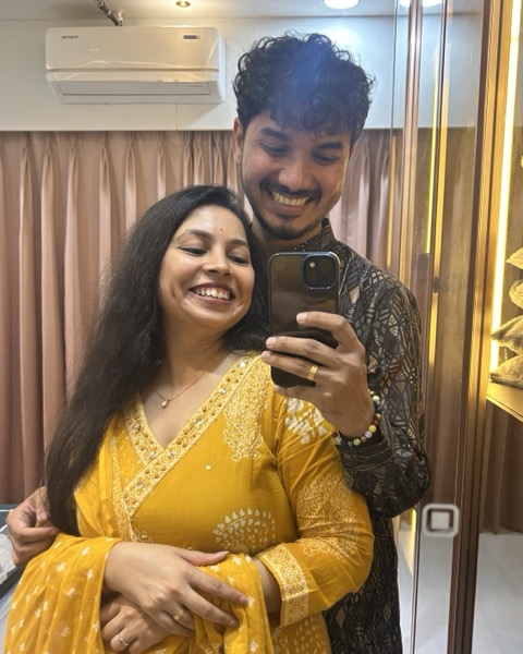 A mirror selfie of the two of us, smiling, with a yellow dupatta and a dark printed kurta