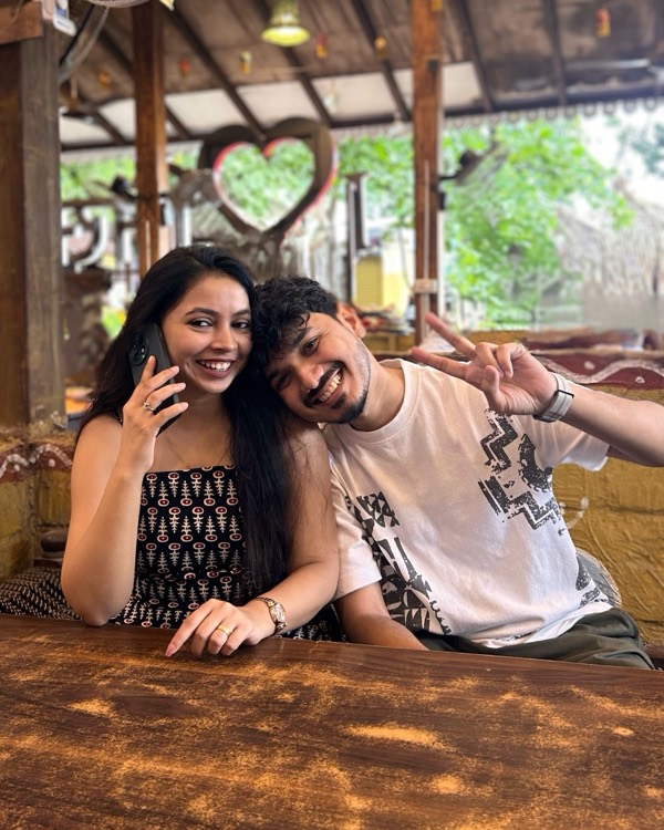 The two of us laughing together at a cafe, with a heart-shaped frame behind us