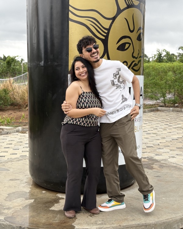 The two of us hugging in front of a giant wine bottle